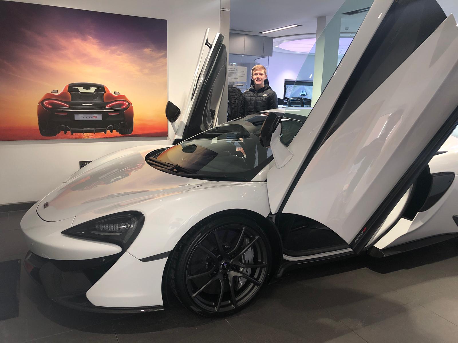 White McLaren 570S Spider with its dihedral doors open